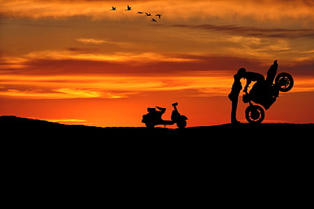 man riding motorcycle kissing girl silhouette thumbnail