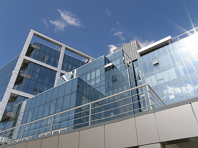 clear glass and gray concrete building in low angle photography thumbnail
