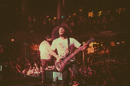 man playing guitar on black stage thumbnail