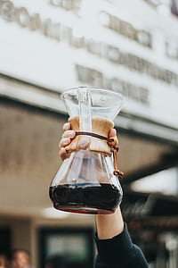 person holding glass pitcher thumbnail