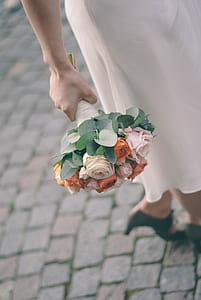 person holding pink and orange roses thumbnail
