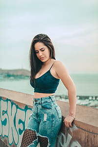 woman taking selfie while looking down thumbnail