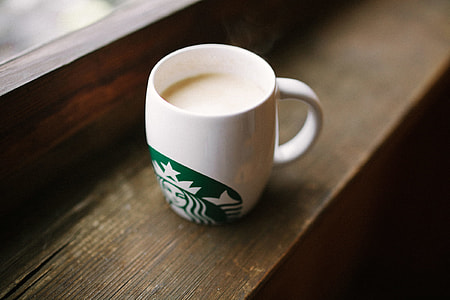white ceramic starbucks mug on top of brown wooden surface thumbnail