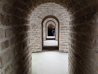 woman standing beside brown wall bricks thumbnail