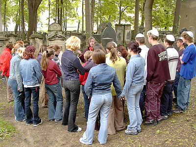 group of people gathering in middle of woods thumbnail