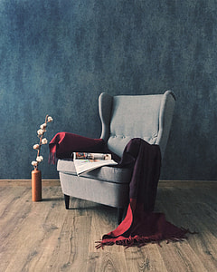 gray padded wing chair with red scarf on top thumbnail