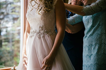 woman standing beside clear glass window thumbnail