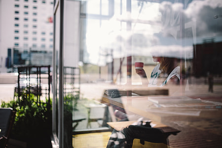 Woman reading book at coffee shop thumbnail