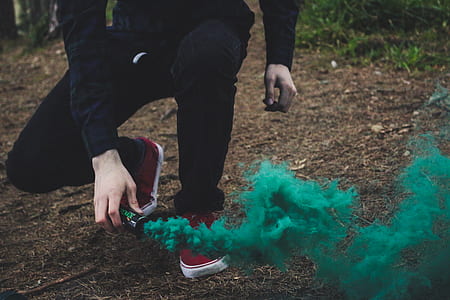 person holding green smoke bomb thumbnail
