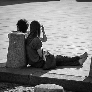 man and woman sitting on concrete floor thumbnail