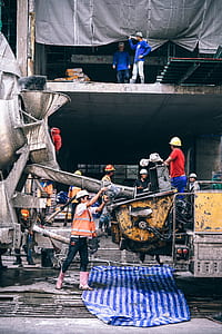 construction workers near concrete building during daytime thumbnail