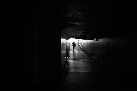 silhouette photography of person walking hallway thumbnail