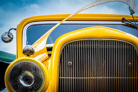 selective focus photo of classic yellow vehicle thumbnail