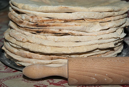closeup photo of baked pastry near brown rolling pin thumbnail