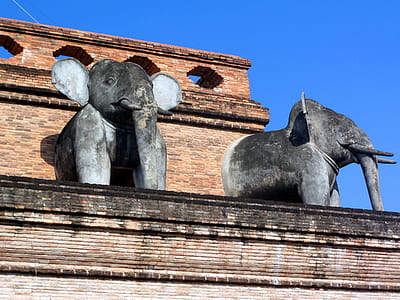 Sacred Buddhist elephant sculptures at Chedi Luang Buddhist temple in Chiang Mai, Thailand thumbnail