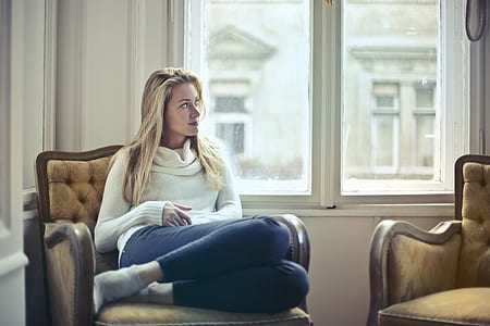 woman sitting near closed window looking sideways thumbnail