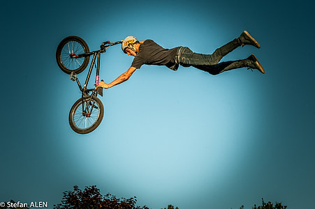 man holding BMX bike making stunt thumbnail