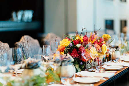 dinning table with plates and flowers arrangement thumbnail