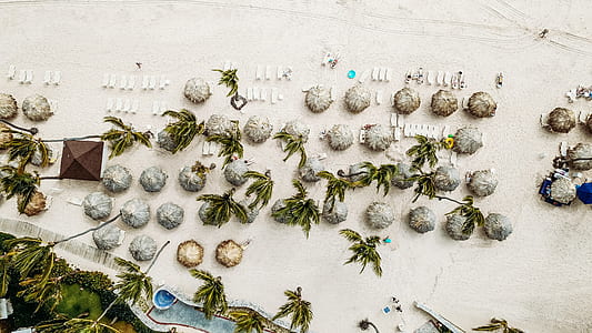 aerial photo of brown gazebos in seashore at daytime thumbnail