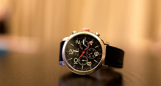 round silver-colored chronograph watch with black band at 12:14 thumbnail