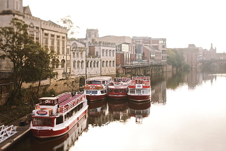 four red boats docks near city thumbnail