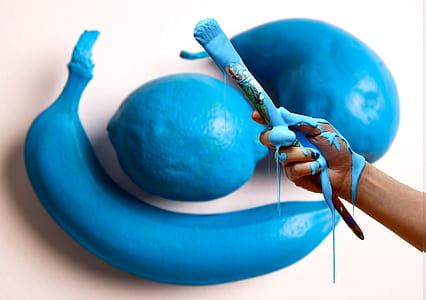 person holding blue paintbrush thumbnail