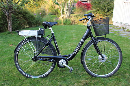black step-through bicycle on green grassfield thumbnail
