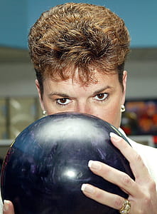 woman holding bowling ball thumbnail