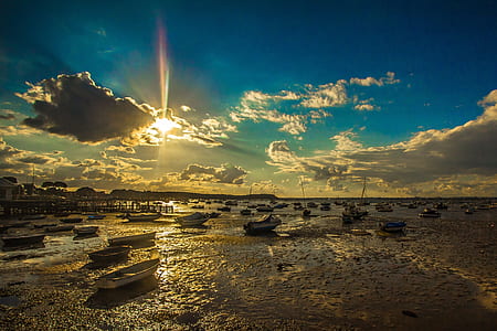 white boats on dry ocean during daytime thumbnail