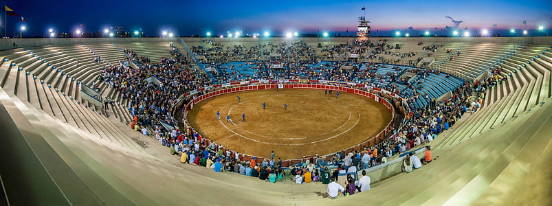people gathered at the event inside bull riding stadium thumbnail
