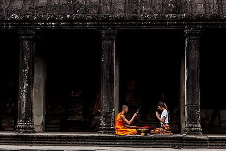 Woman Sitting in Front of Monk thumbnail
