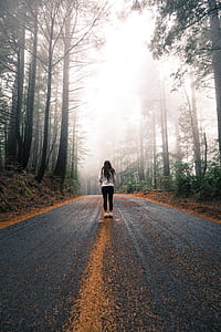 woman standing on concrete road path thumbnail