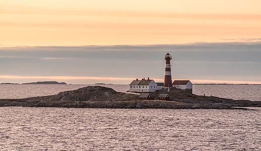 white and red lighthouse on island during sunset thumbnail