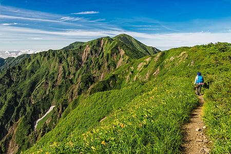 person climbing on mountains during daytime thumbnail