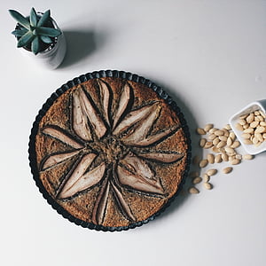 baked cake near bowl of nuts and succulent plant thumbnail