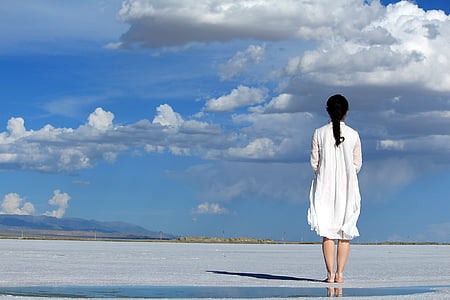 woman wearing white dress while standing on flat surface thumbnail