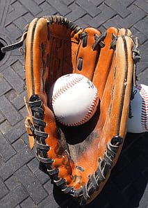 white baseball on brown baseball mitt thumbnail