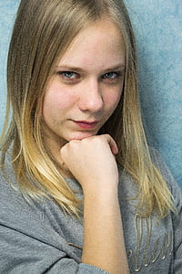 woman in gray sweater posing for a photo thumbnail