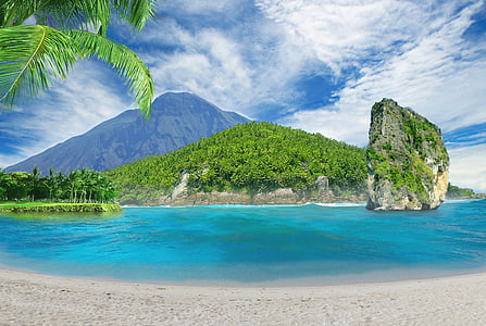 photo of island near mountain at daytime thumbnail