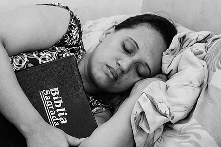 woman sleeping while holding a bible thumbnail