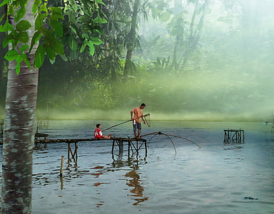 man standing on dock bridge while holding fishing rod thumbnail
