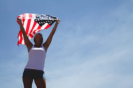 woman holding U.S.A. flag thumbnail