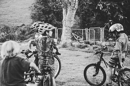 Grayscale Photography of Children Riding Bicycles thumbnail