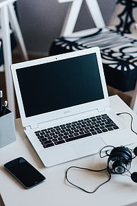 White laptop with smartphone and headphones thumbnail