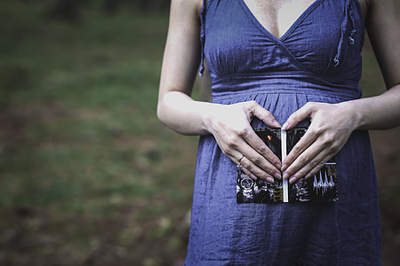 woman holding black book thumbnail