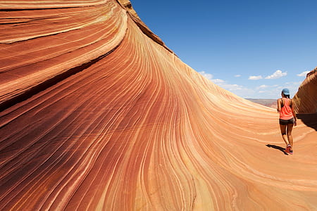 woman walking on brown surface at daytime thumbnail