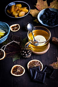 silver-colored spoon on top of clear glass mug filled with liquid and sliced lemon thumbnail