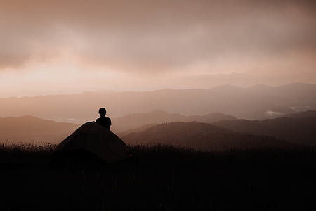 silhouette of person standing on mountain thumbnail