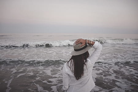 woman holding her gray hat thumbnail