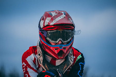 closeup photo of man wearing red and white full-face helmet thumbnail